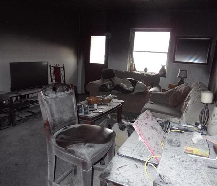 Apartment living room with soot on furniture from fire. 