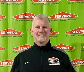 Man in front of servpro sign